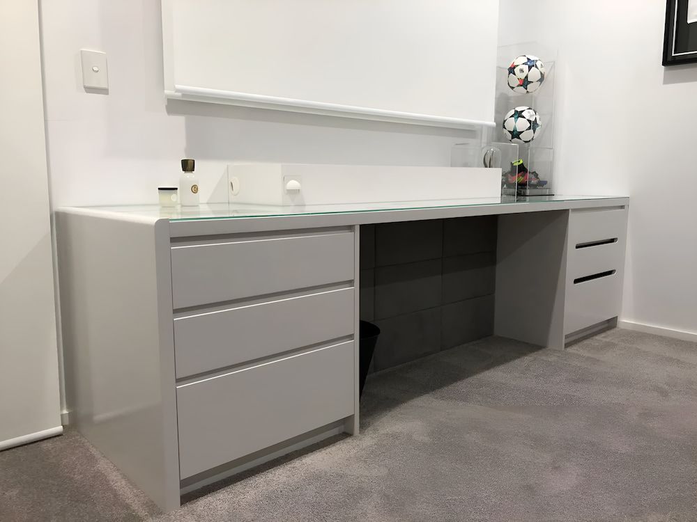 A White Desk With Drawers In A Room With Soccer Balls On The Wall — United Kitchens and Joinery in Oak Flats, NSW