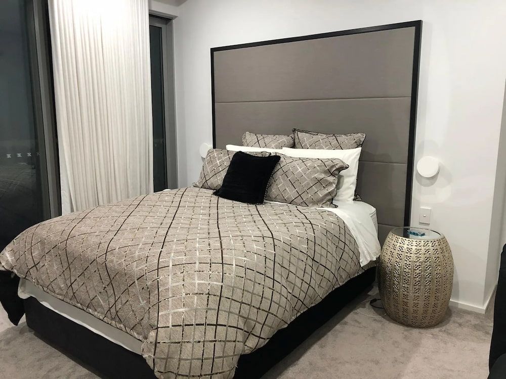 A Bedroom With A Large Bed And A Nightstand — United Kitchens and Joinery in Oak Flats, NSW