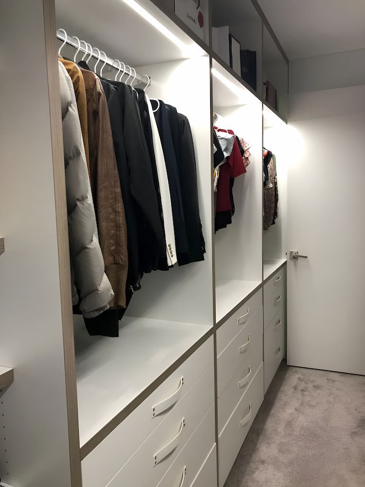 A Walk In Closet Filled With Clothes And Drawers — United Kitchens and Joinery in Oak Flats, NSW