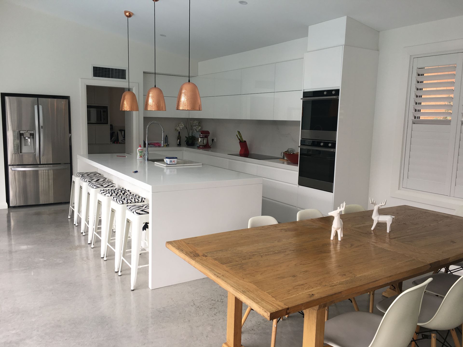 A Kitchen With White Cabinets, Stainless Steel Appliances, And A Large Island — United Kitchens and Joinery in Berry, NSW