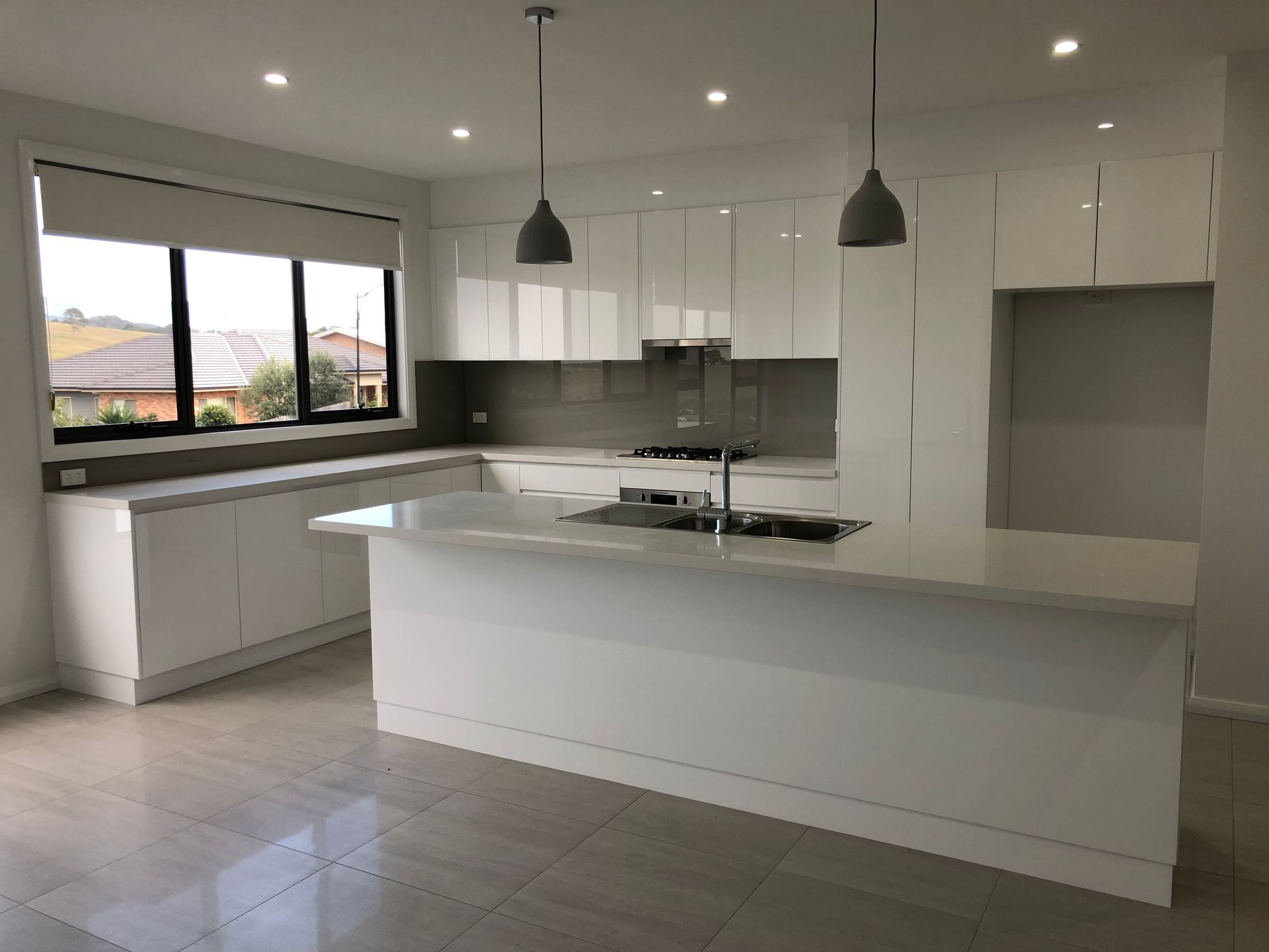 A Kitchen With A Black White Countertop And Downlights — United Kitchens and Joinery in Vincentia, NSW