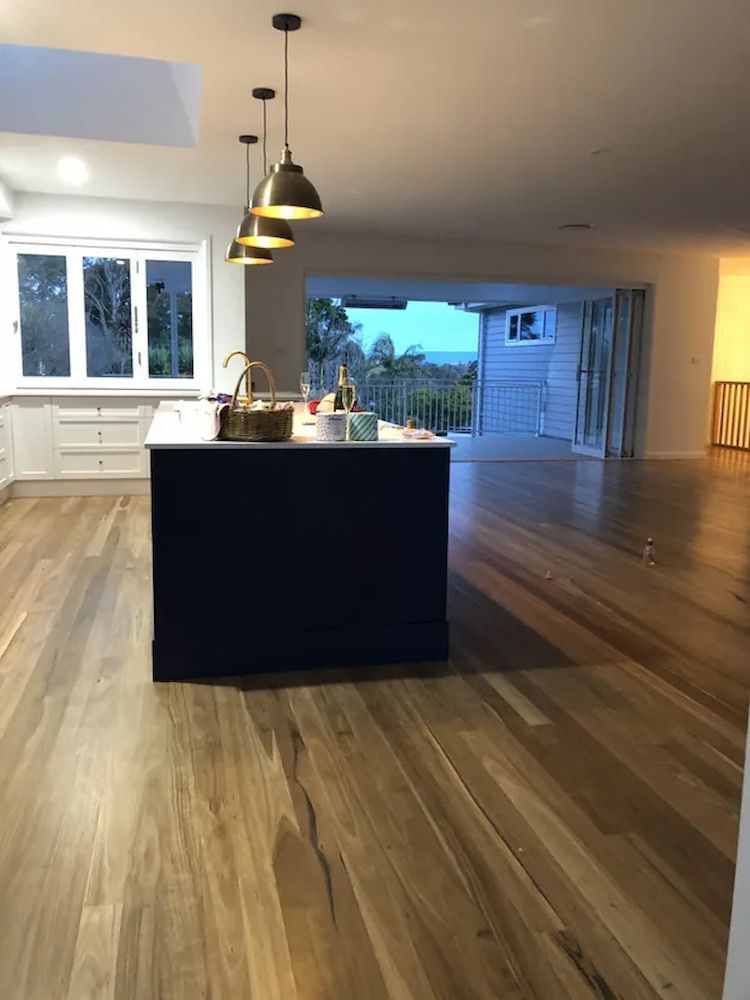 A Kitchen With A Large Island In The Middle Of The Room — United Kitchens and Joinery in Oak Flats, NSW