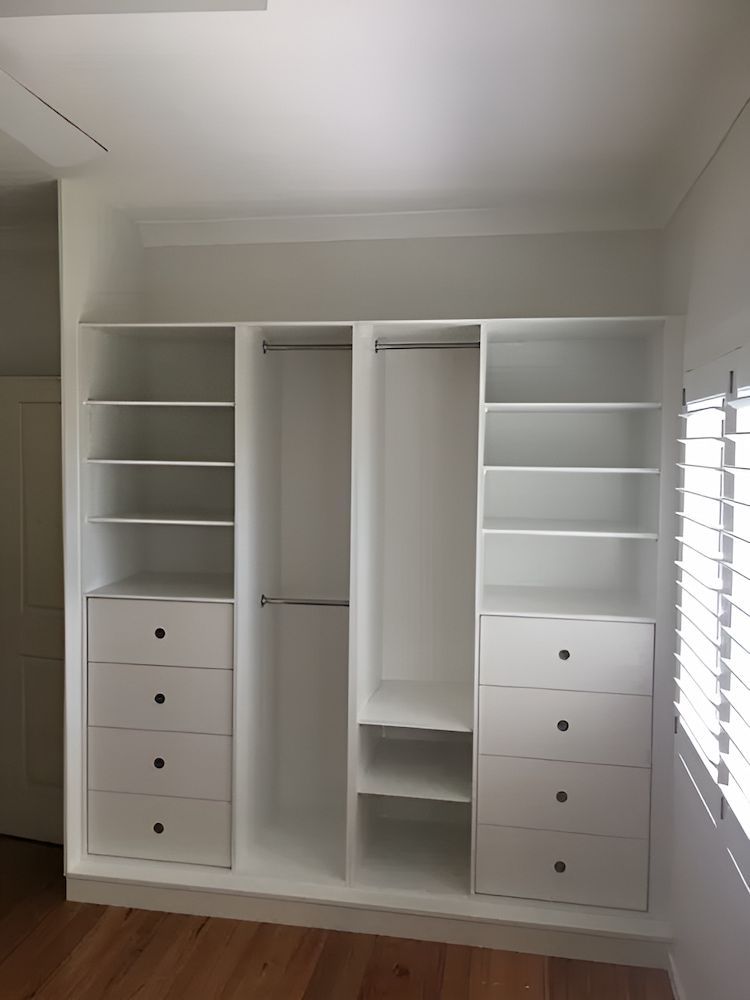 A Closet With Lots Of Shelves And Drawers And A Window — United Kitchens and Joinery in Oak Flats, NSW