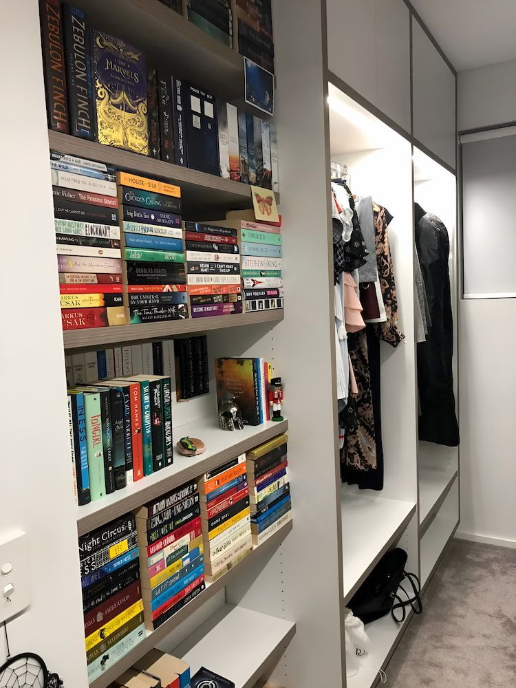 A Closet Filled With Lots Of Books And Clothes — United Kitchens and Joinery in Oak Flats, NSW