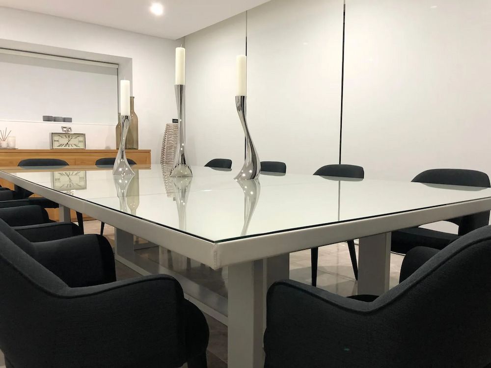 A Conference Room With A Table And Chairs And Candles On It — United Kitchens and Joinery in Oak Flats, NSW