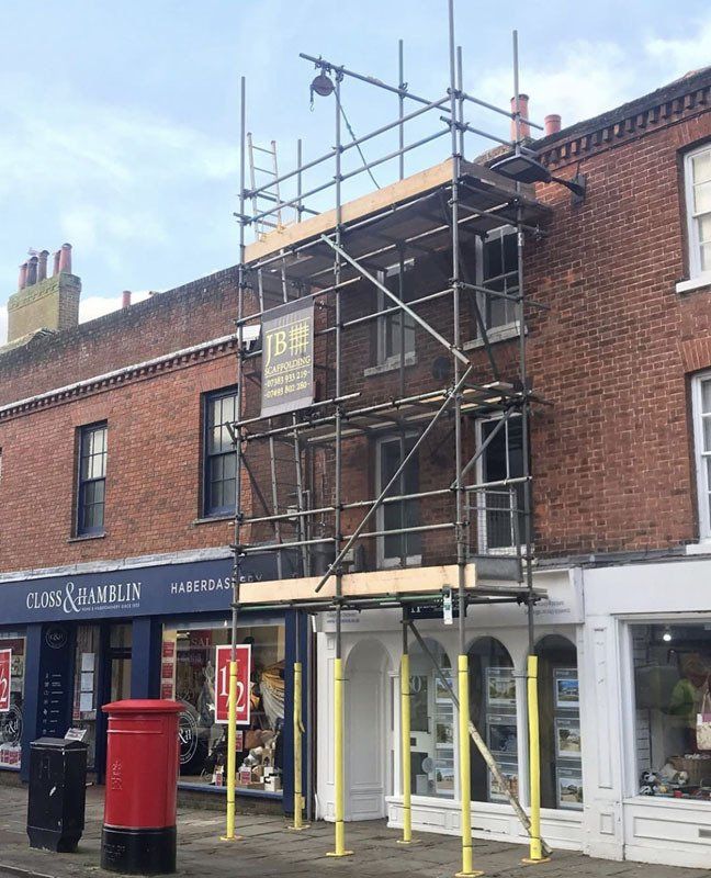 large house with scaffold with  a garden 11