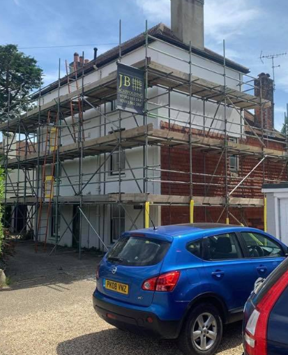 large house with scaffold from a wide shot