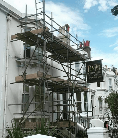 scaffold on a white house from down low