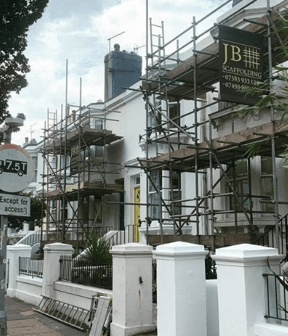 scaffold on a white house, front of house