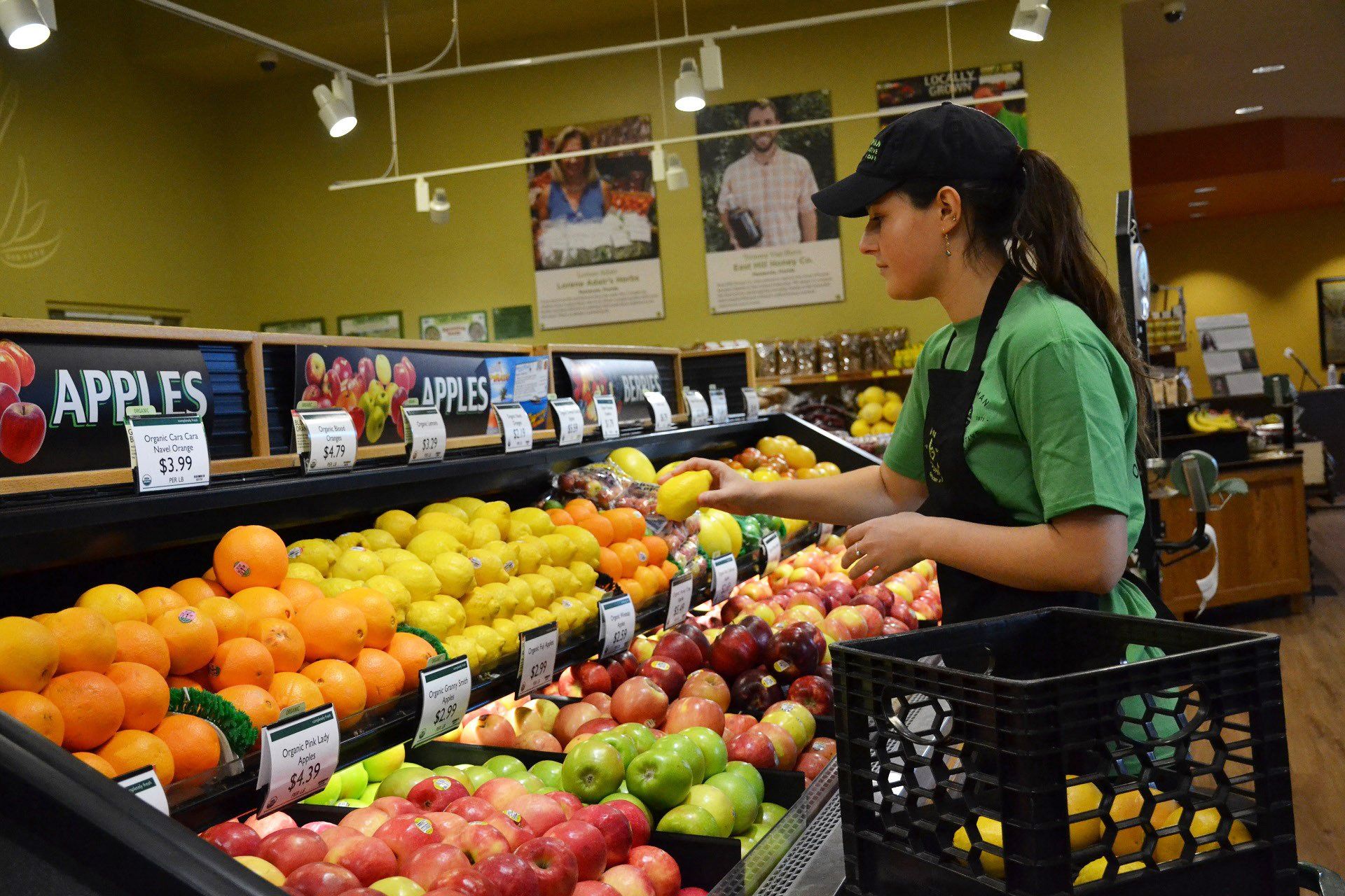 Employee Stocking Fruit at Local Health Food Store