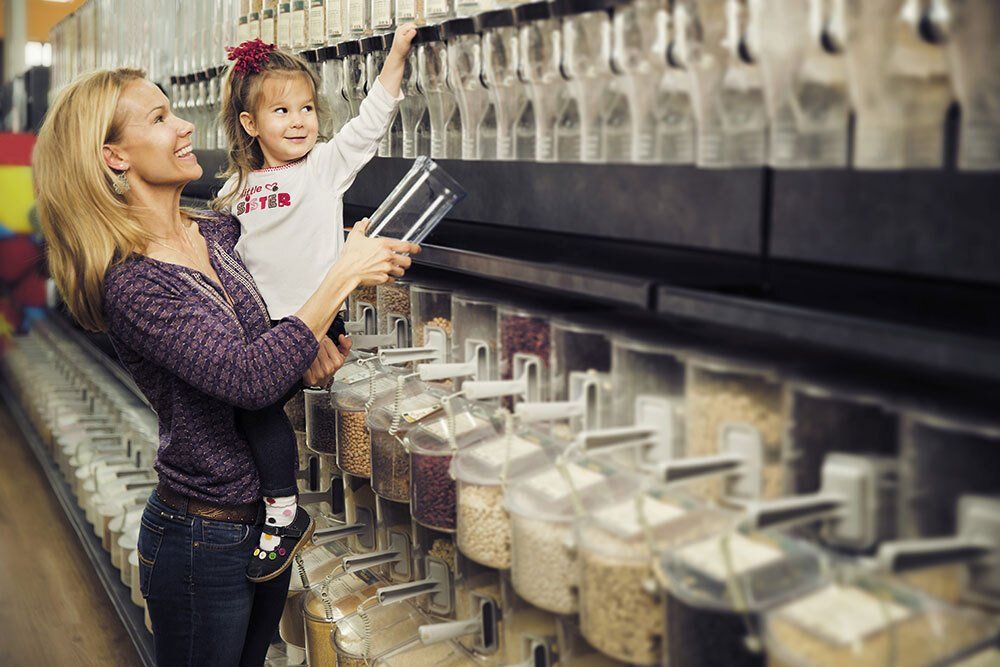 Mother and Daughter in Bulk Section at Local Health Food Store