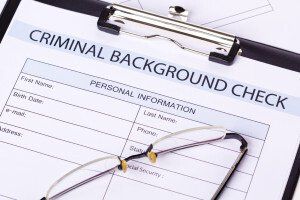 criminal background check form on a clipboard