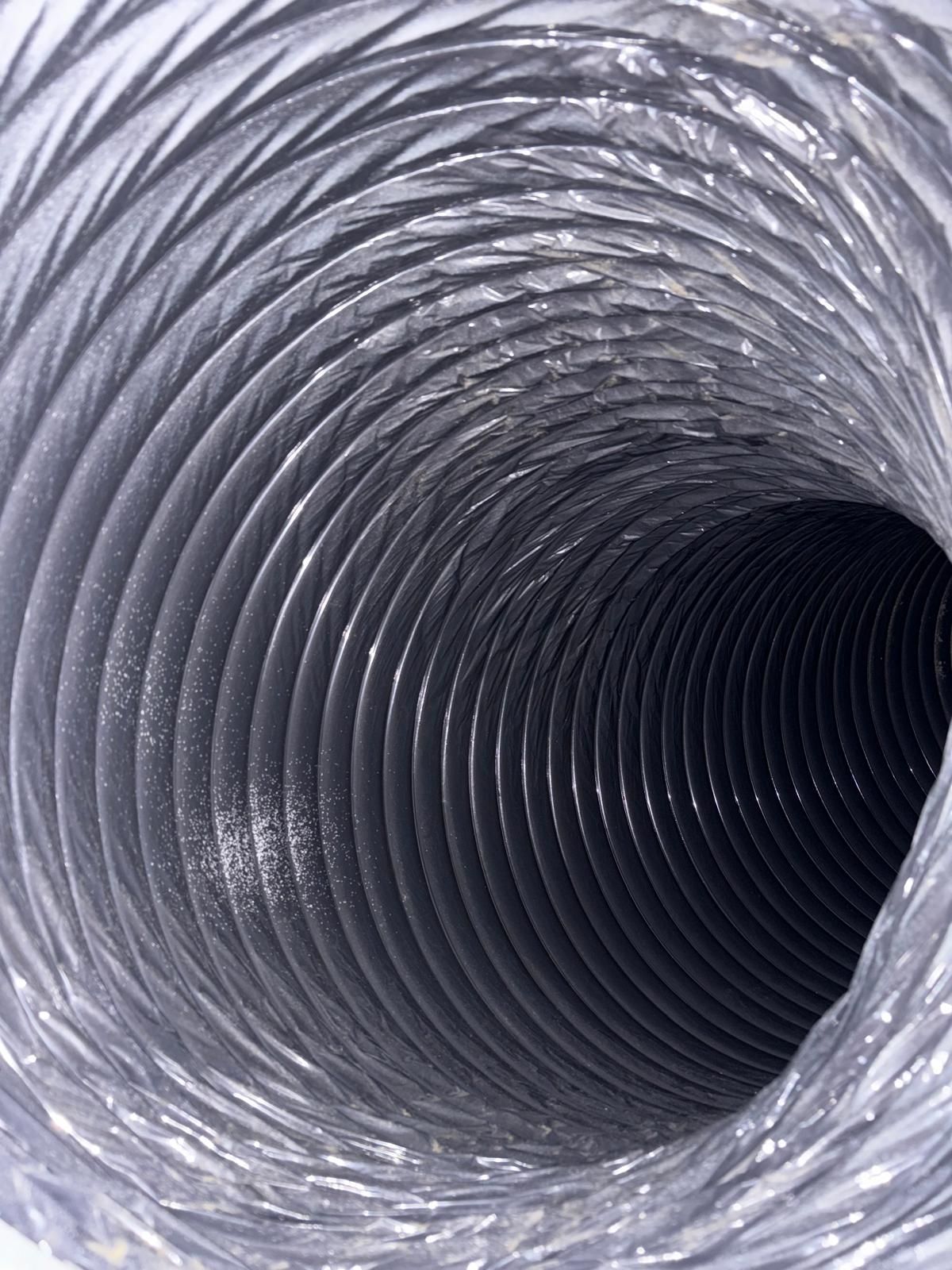 Inside view of a flexible, metallic dryer vent tube.