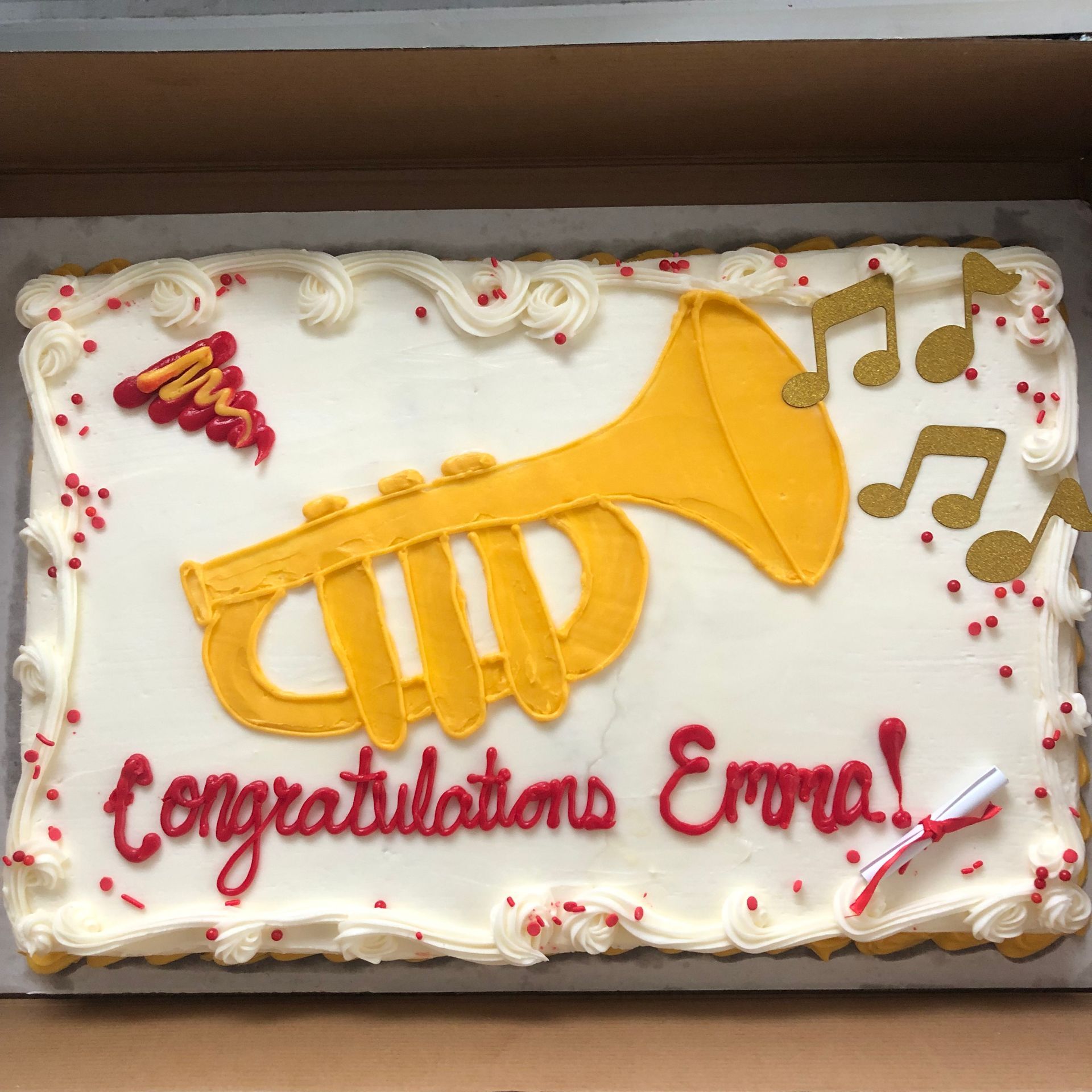 A graduation cake that says congratulations emma on it