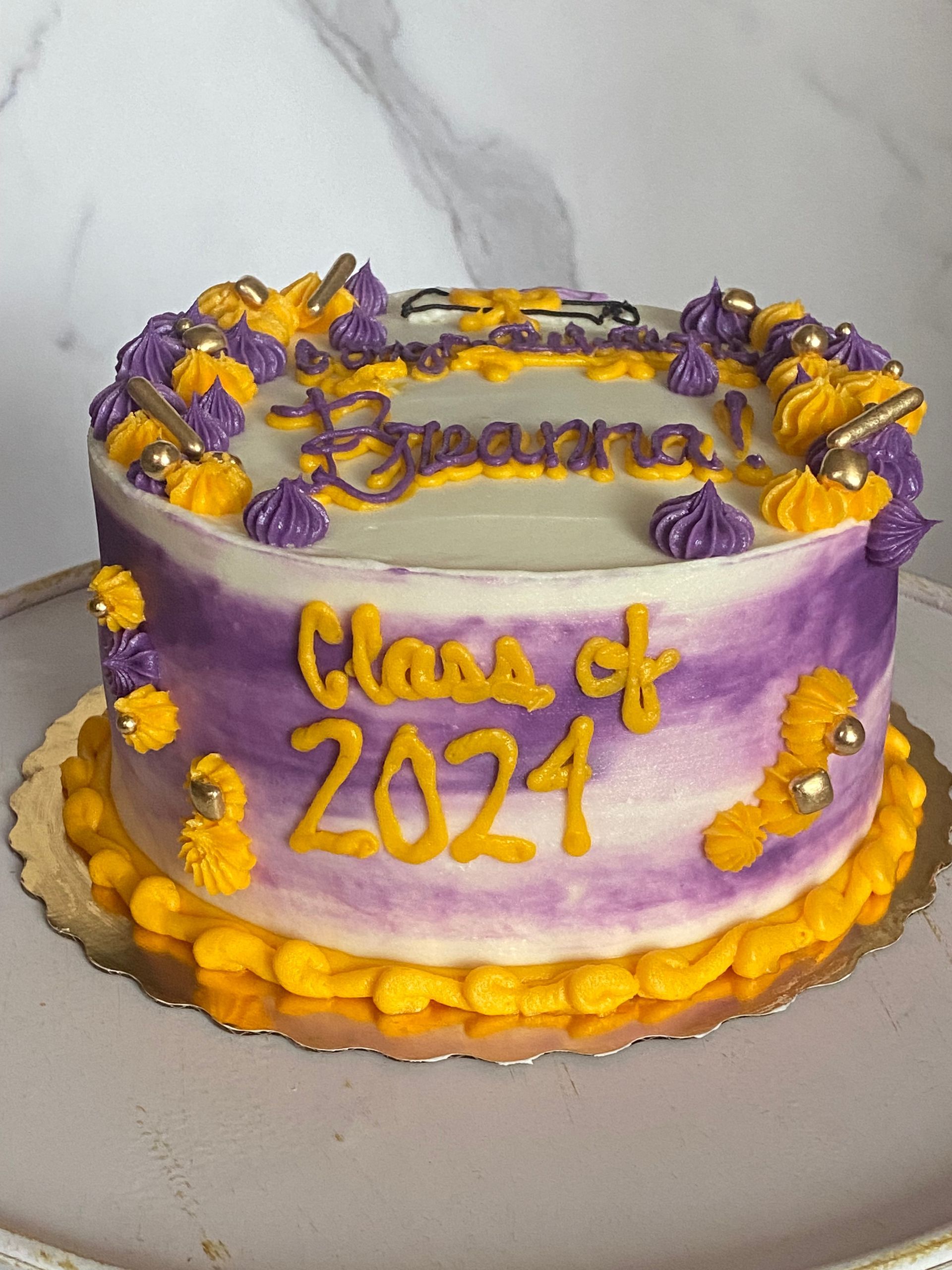 A Nevada purple and yellow cake with the words class of 2024 on it