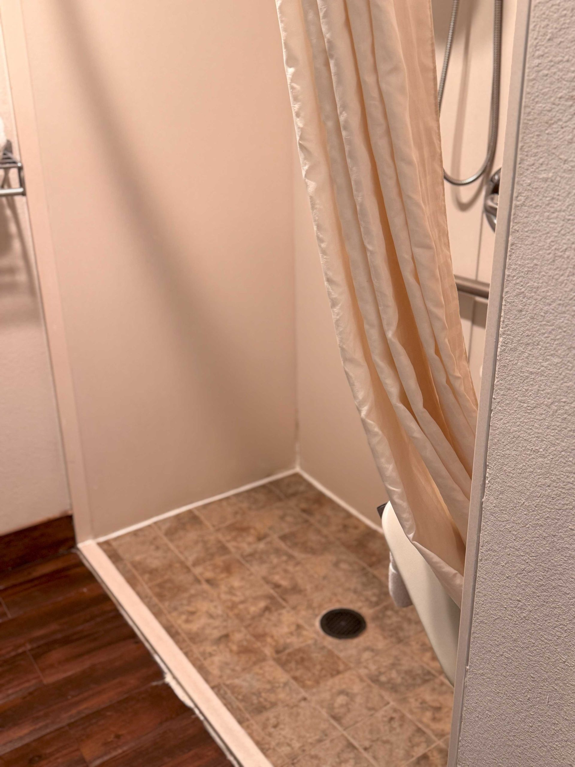 A bathroom with a walk in shower and a bathtub.