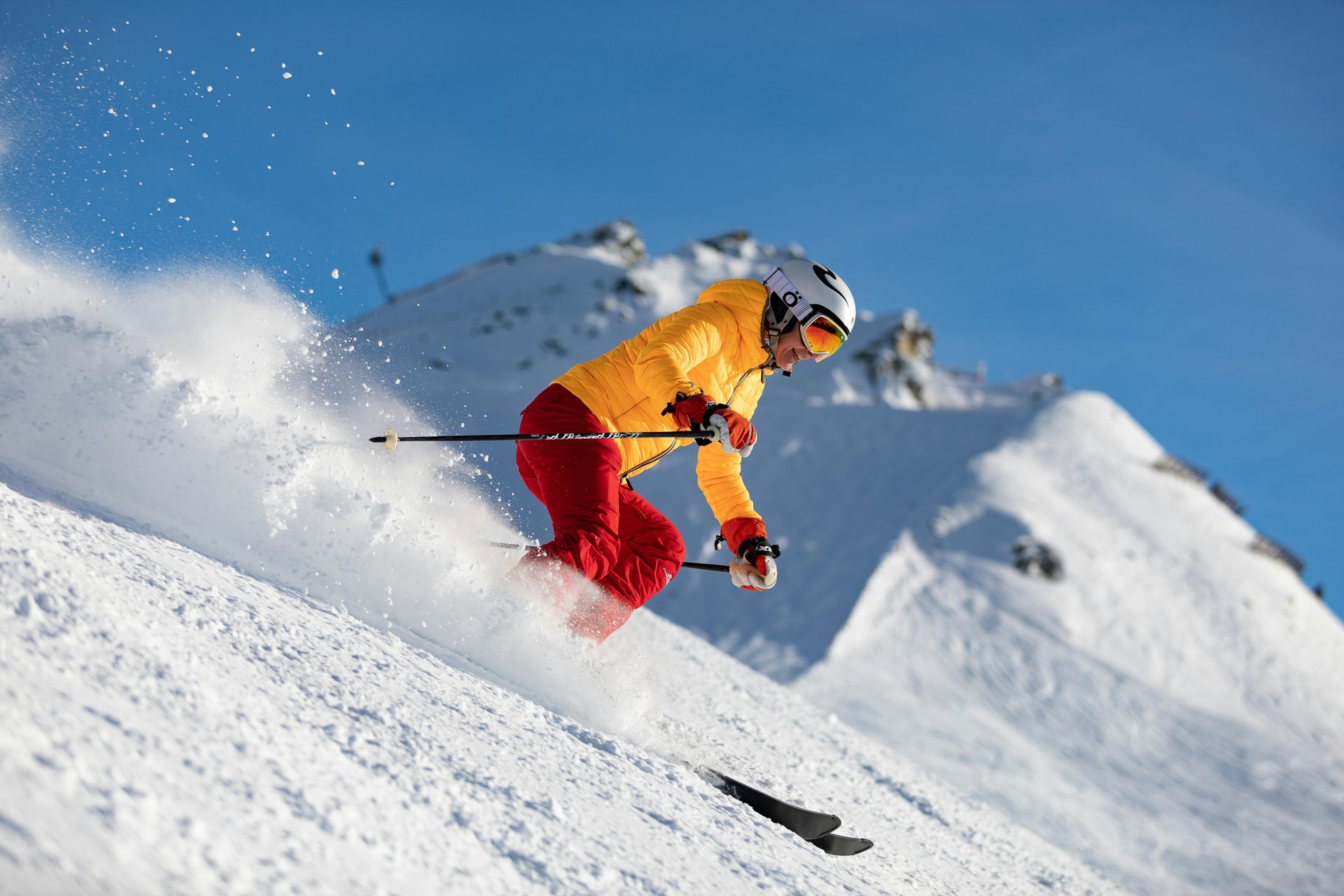 A person is skiing down a snow covered slope.