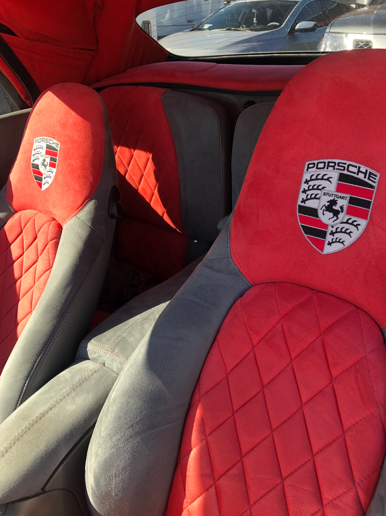 A red and gray porsche car seat