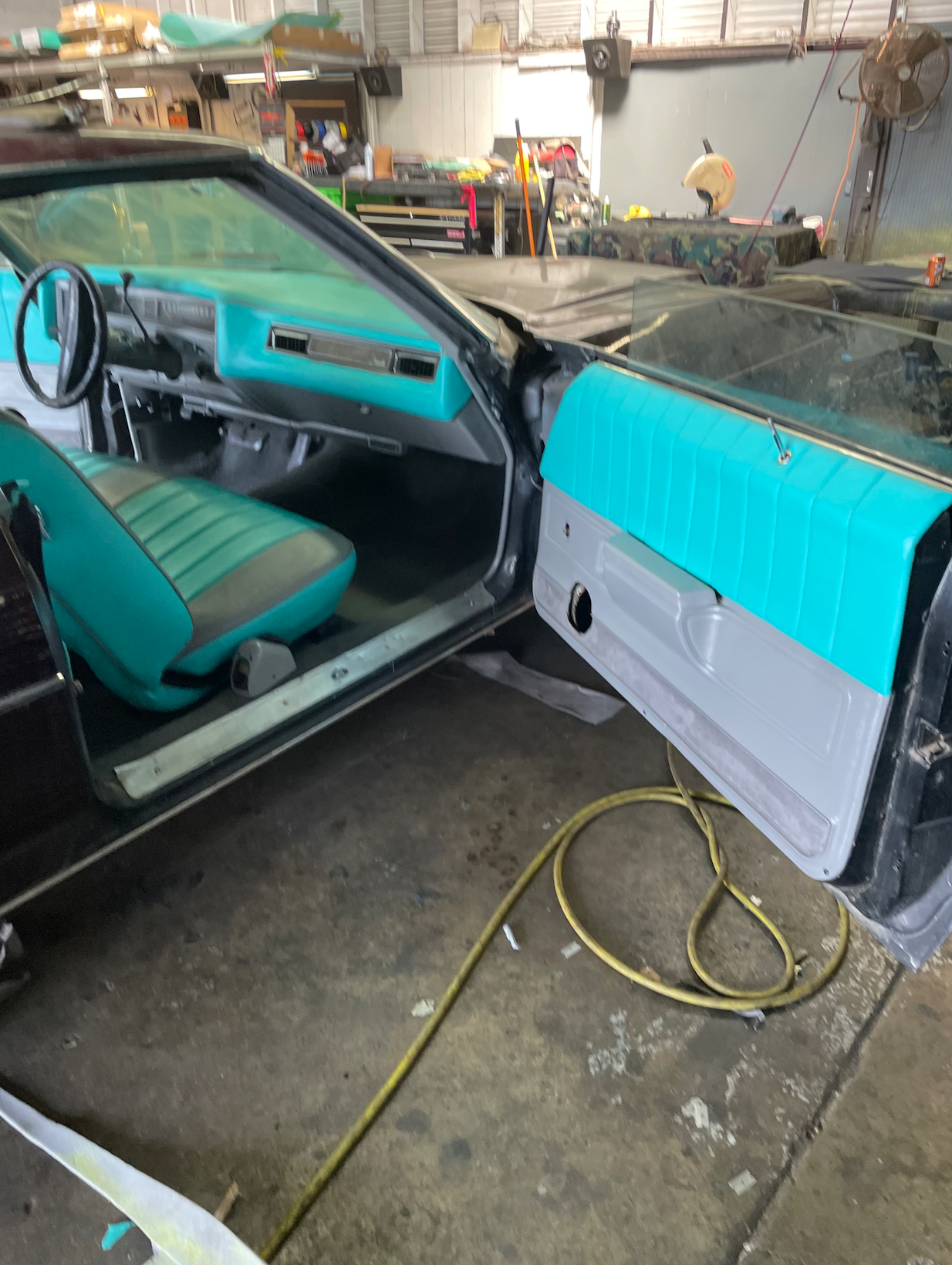 A car with the door open in a garage