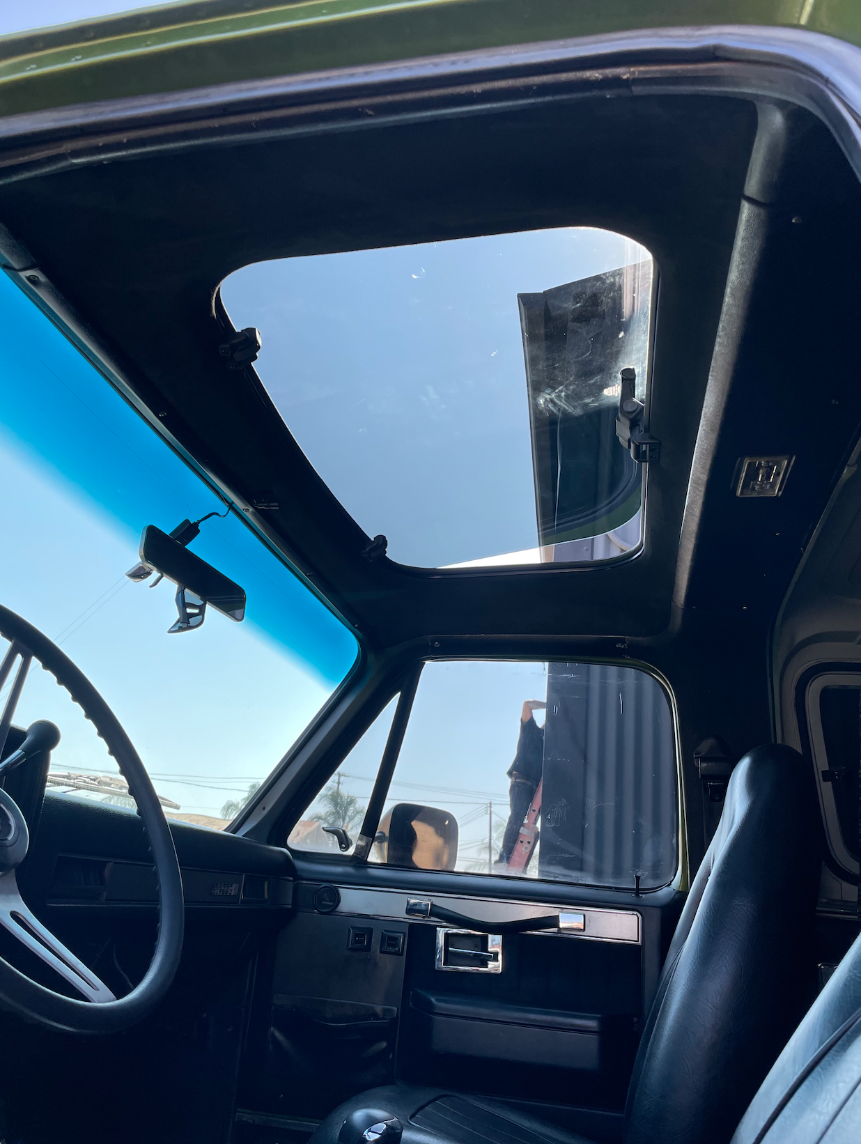 A car with a sunroof and a steering wheel