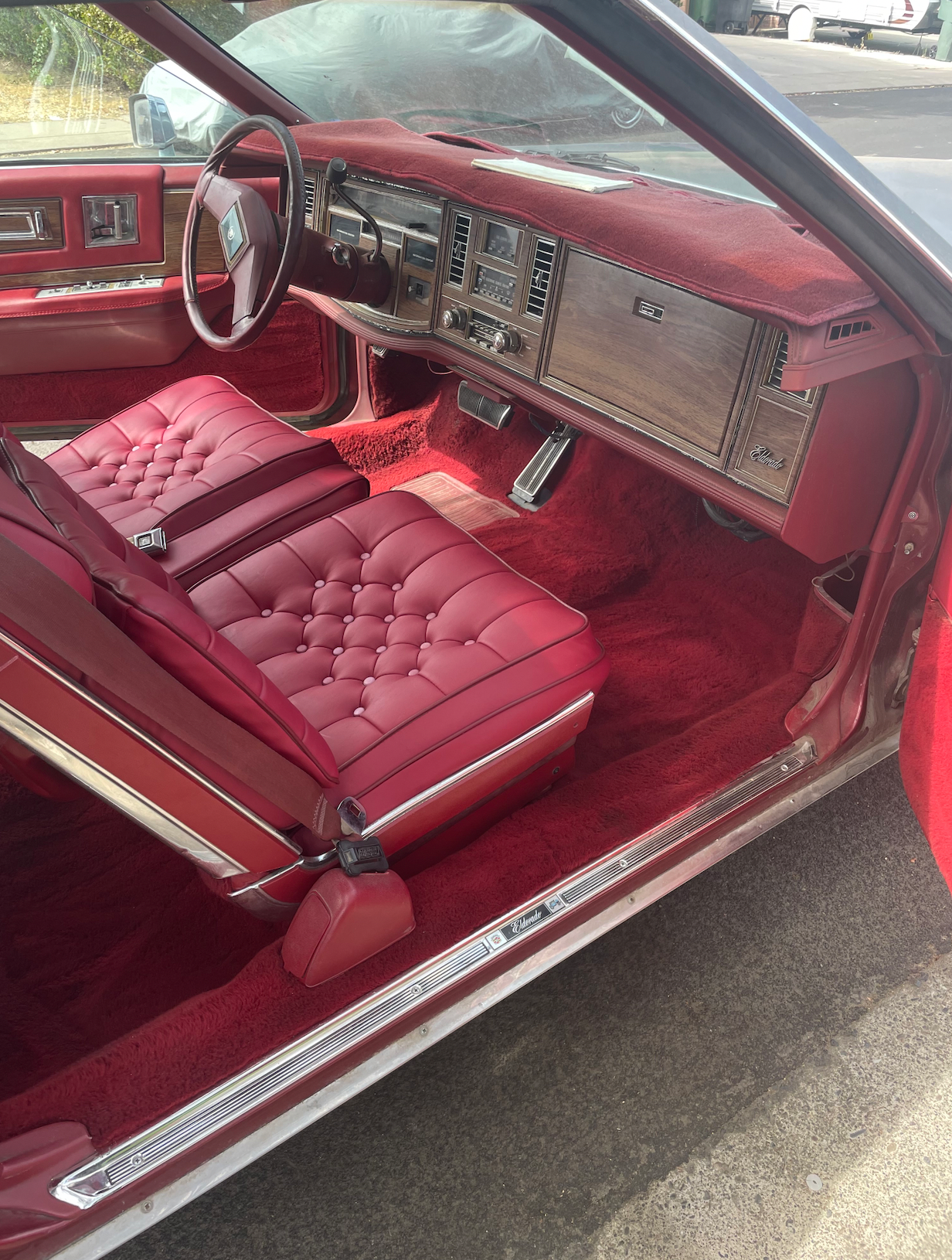 The interior of a car with red seats and red carpet
