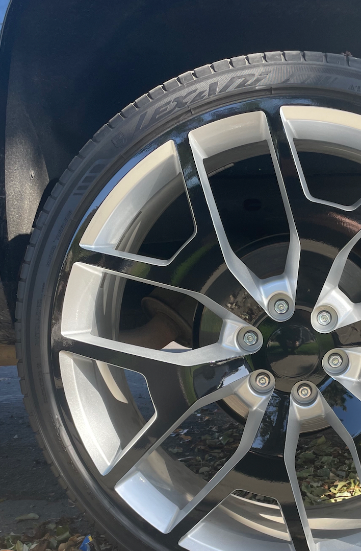 A close up of a car wheel with a tire on it