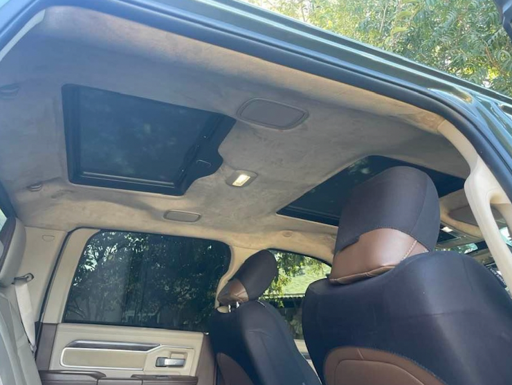 The inside of a car with the sunroof open