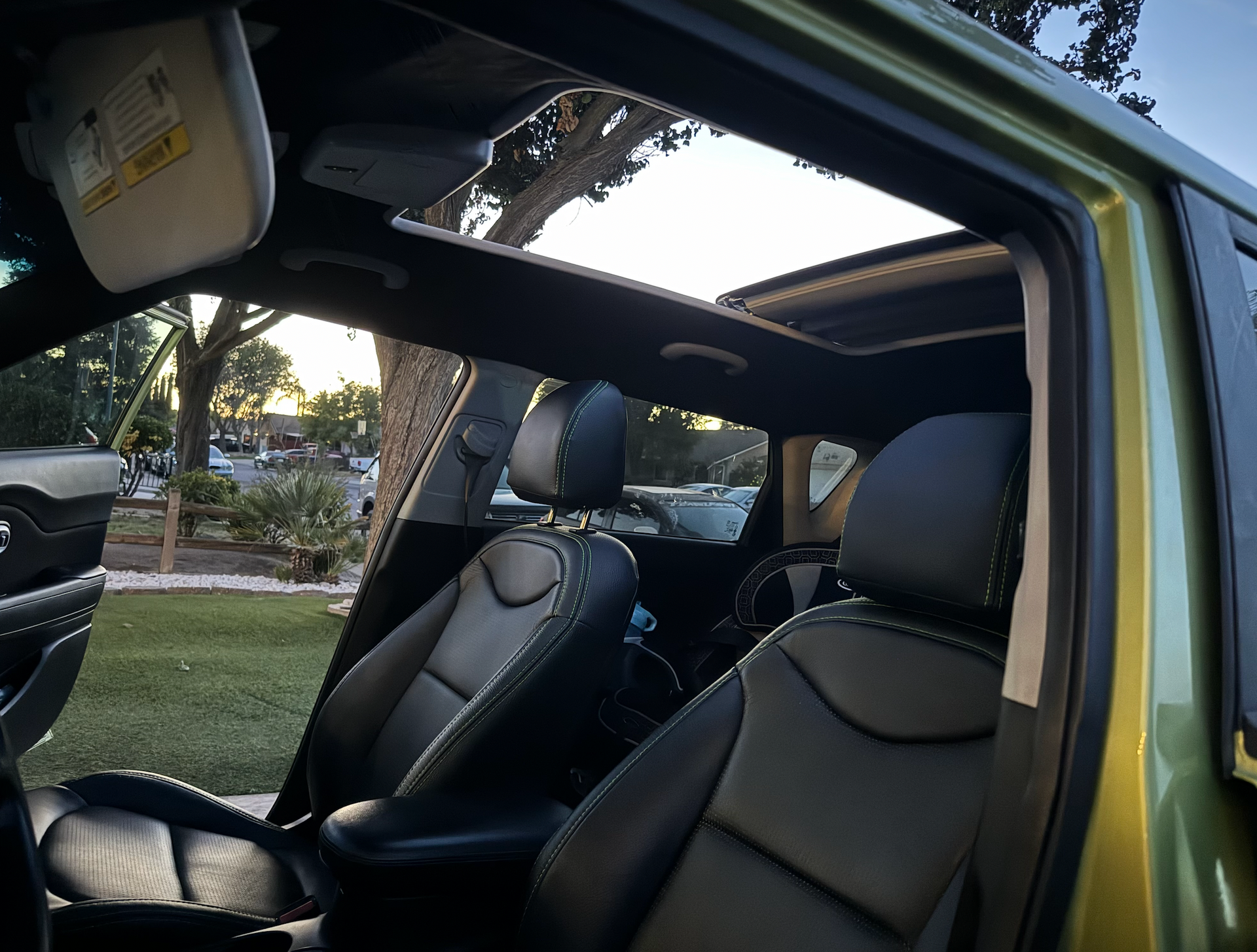 The inside of a car with the sunroof open