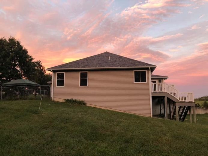 The roof of a house with a blue sky in the background.