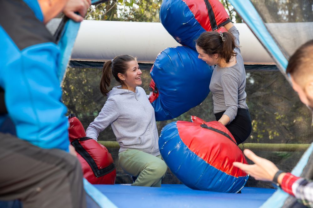A large pink climbing wall with a tree on it