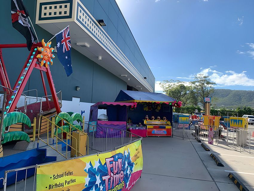 A Carnival With a Ferris Wheel in Front of a Building — Fun Time Amusements in Gracemere, QLD