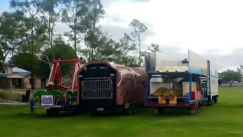 A Group of Carnival Rides Are Parked in a Grassy Field — Fun Time Amusements in Gracemere, QLD