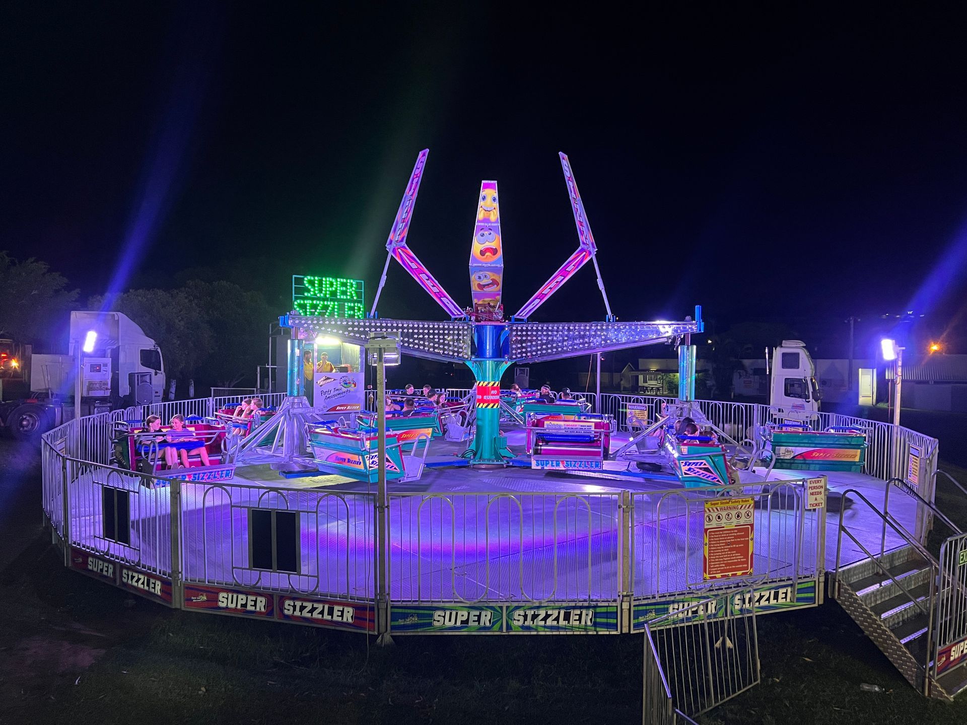 A Merry Go Round is Behind a Fence in a Field — Fun Time Amusements in Gracemere, QLD