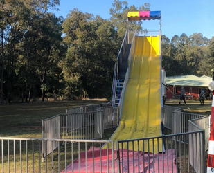 Giant Yellow Slide at a Carnival at Night — Fun Time Amusements in Gracemere, QLD