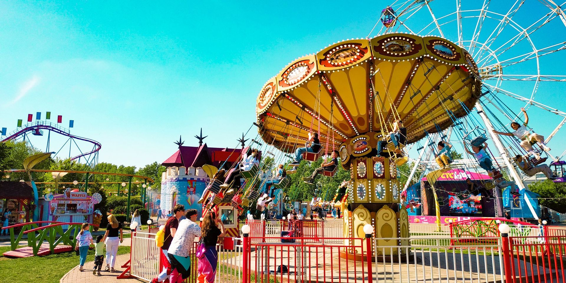 A Merry Go Round is Behind a Fence in a Field — Fun Time Amusements in Biloela, QLD