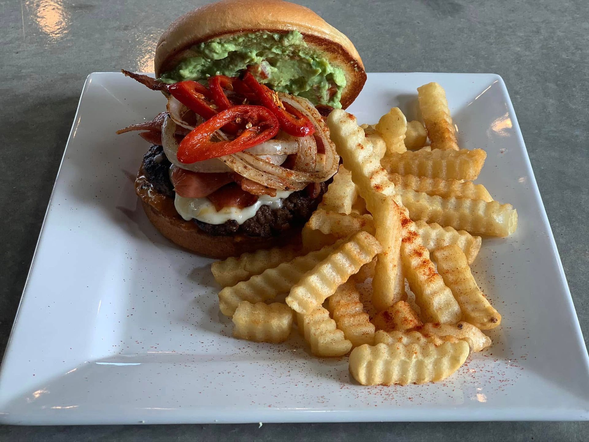 A white plate topped with a hamburger and french fries