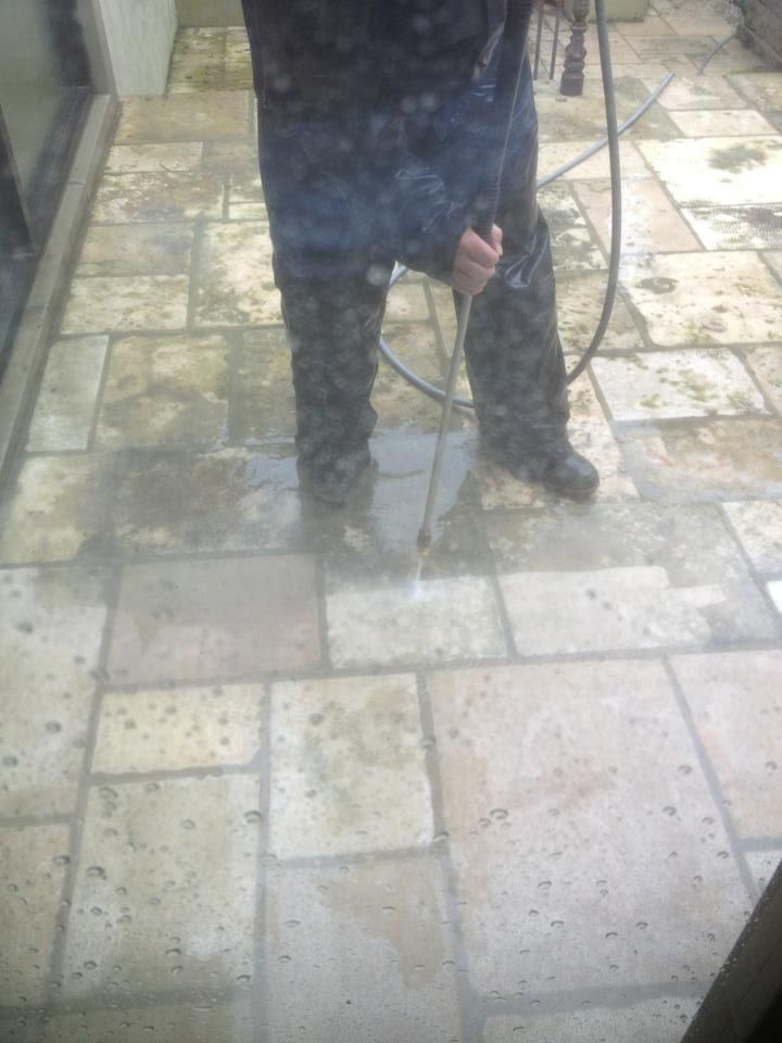Carpet Master of Tulsa - A person is cleaning a tiled floor with a high pressure washer.