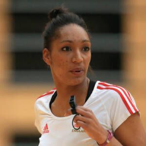 A woman is wearing a white adidas shirt