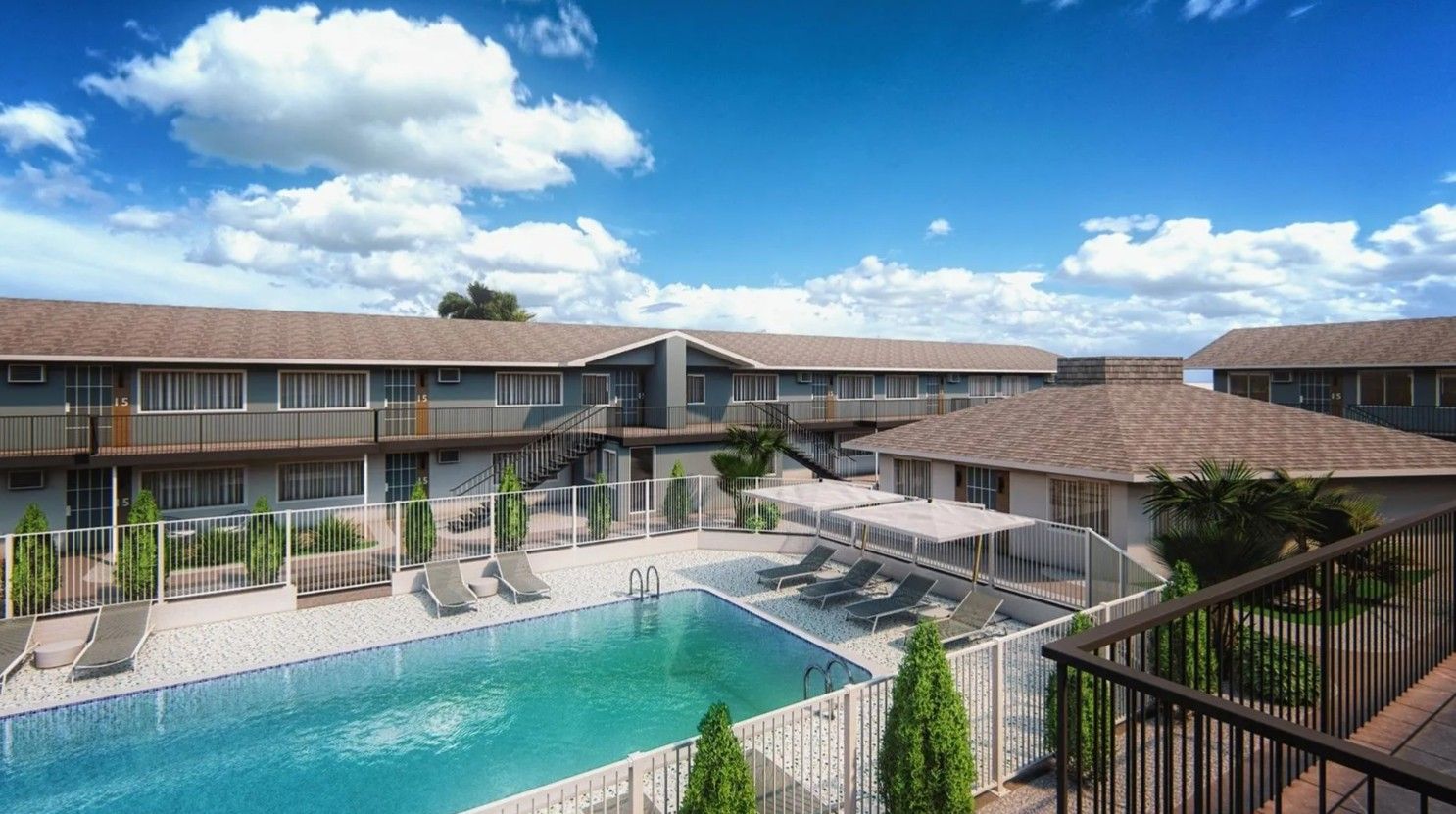 Modern resort courtyard with turquoise pool, lounge chairs, and two-story buildings under a blue sky