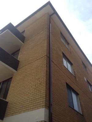 A large brick building with a lot of windows and balconies.