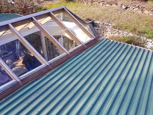 A green roof with a skylight on top of it.