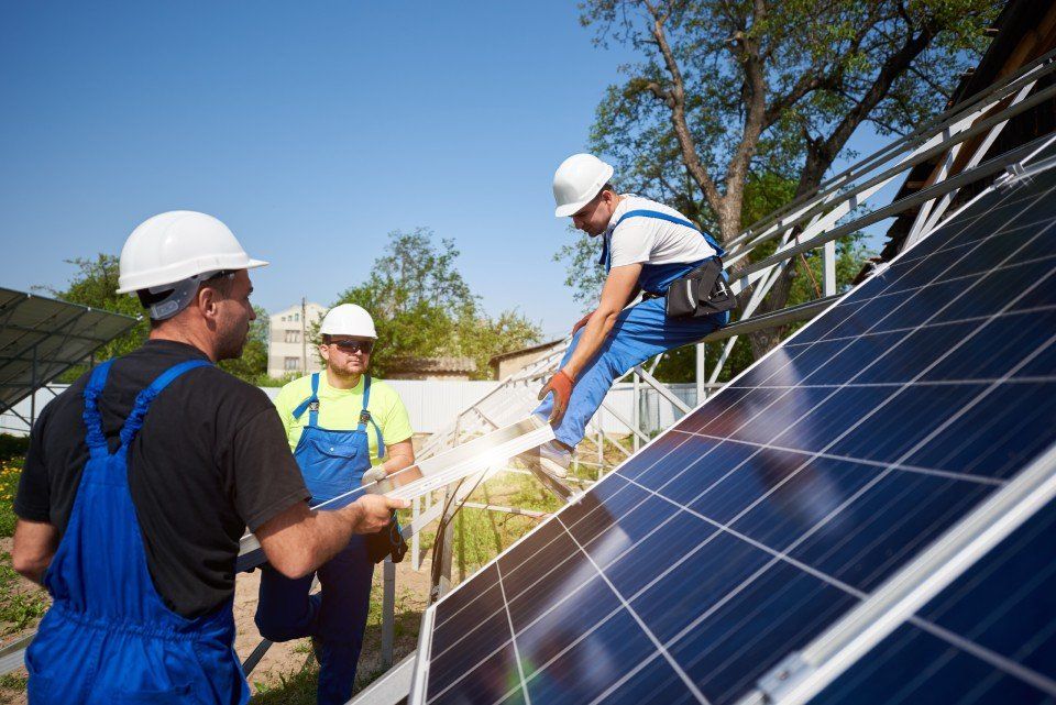 tre operai al momento dell'installazione di pannelli solari