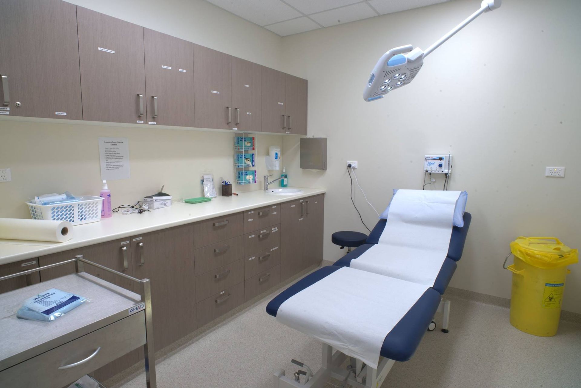 A Hospital Room With A Bed And A Yellow Trash Can — Logic Joinery In Fountaindale, NSW