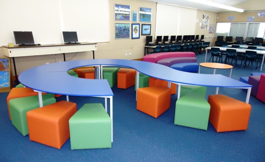 A Classroom With Blue Tables And Colorful Stools — Logic Joinery In Fountaindale, NSW