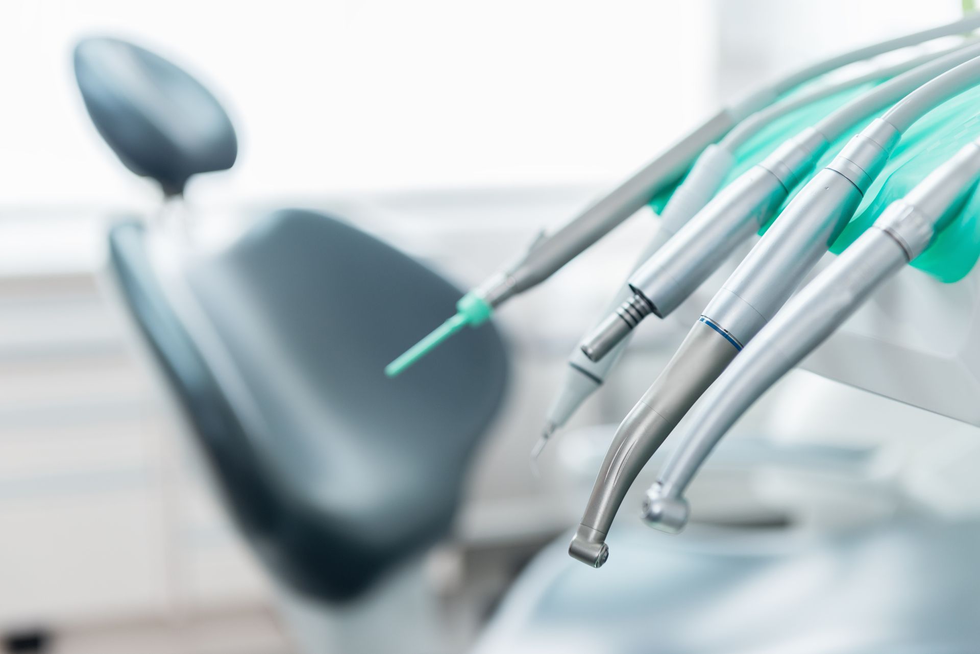 Dental tools and chair, medical setting.