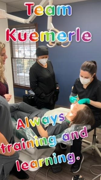 Team Kuemmerle at a dentist's office; dental work in progress, other team members observing.