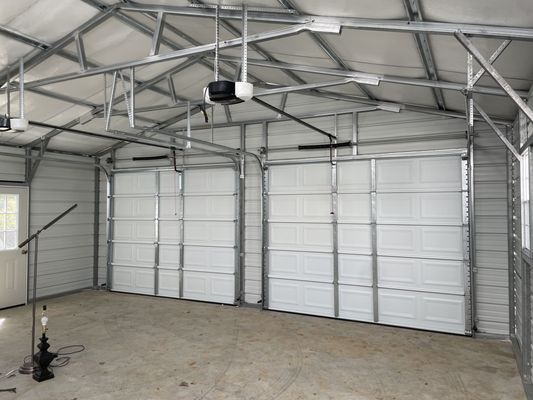 A garage with a lot of doors and a ceiling fan.