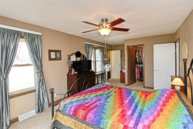 bedroom with pink bed with fan