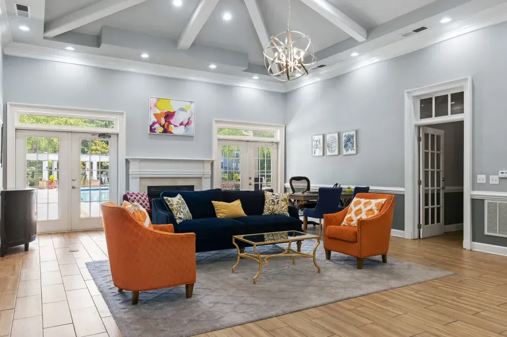 a living room with a couch, chairs, coffee table and fireplace at Marquis on Cary Parkway in Morrisville, NC