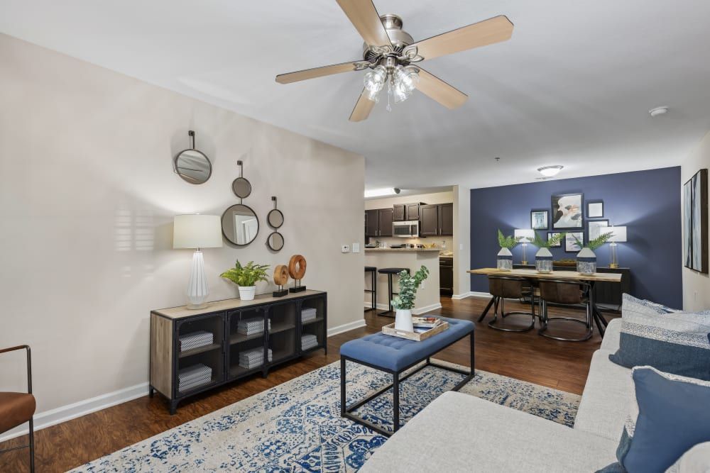 a living room with a ceiling fan and a couch at Marquis on Cary Parkway in Morrisville, NC.
